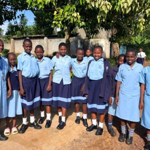 photo of girls in light blue school uniforms smiling